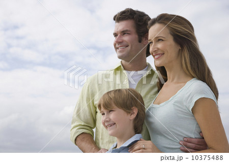 Family with one child under cloudy sky 10375488
