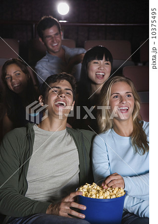Couple laughing in movie theater Couple laughing in movie theater 10375495