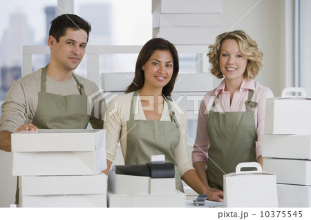 Multi-ethnic bakery workers behind counter 10375545