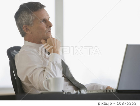 Businessman thinking at desk Businessman thinking at desk 10375555