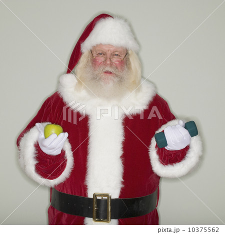 Santa Claus holding apple and dumbbell 10375562