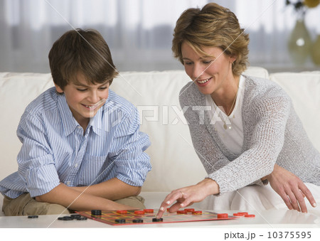 Mother and son playing checkers Mother and son playing checkers 10375595