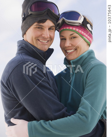 Couple in ski goggles hugging 10375643