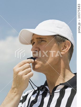 Male referee blowing whistle Male referee blowing whistle 10375683