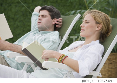 Couple reading in lounge chairs 10375691
