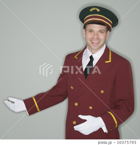 Doorman making welcoming gesture 10375705