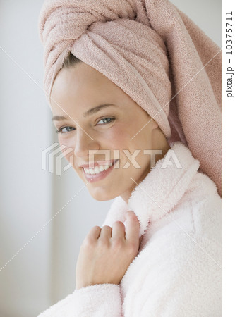 Woman with towel wrapped around hair 10375711