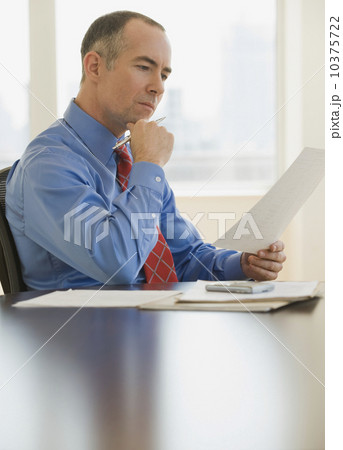 Businessman reading paperwork 10375722