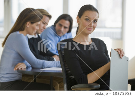 Portrait of businesswoman with business people in background 10375953