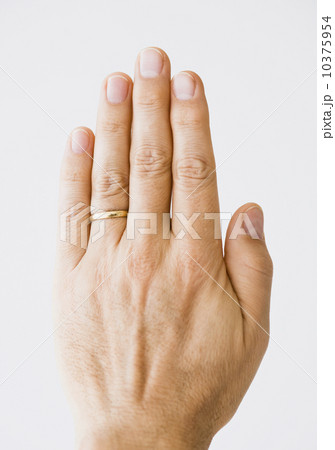 Close up of man’s hand wearing wedding ring Close up of man’s hand wearing wedding ring 10375954