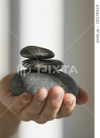 Close up of hand holding three stones Close up of hand holding three stones 10376024