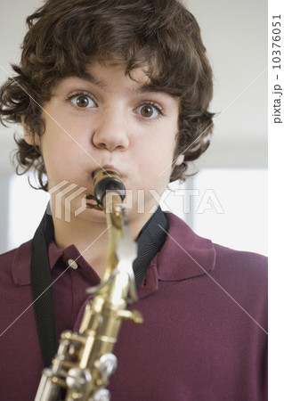 Teenaged boy playing saxophone Teenaged boy playing saxophone 10376051