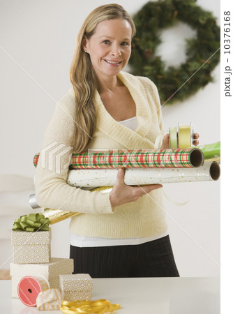 Woman carrying wrapping paper Woman carrying wrapping paper 10376168