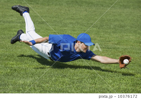 Baseball player diving to catch baseball 10376172