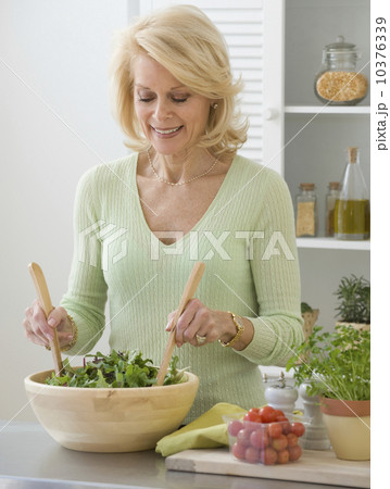 Senior woman tossing salad 10376339