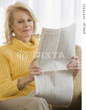 Senior woman reading newspaper 10376341