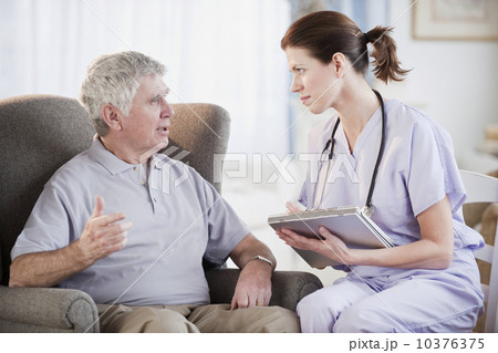 Nurse talking to senior man 10376375