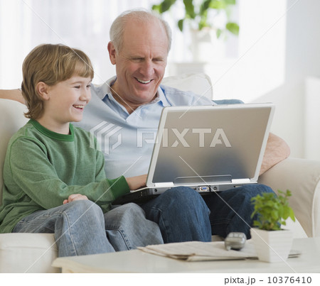 Grandfather and grandson looking at laptop 10376410