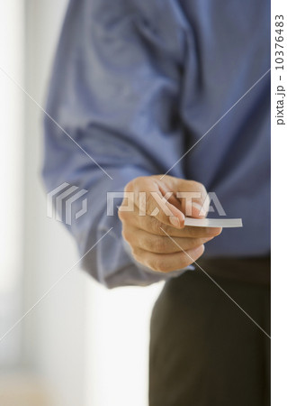 Businessman handing out business card 10376483