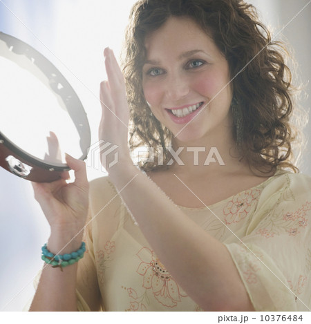 Close up of woman playing tambourine Close up of woman playing tambourine 10376484