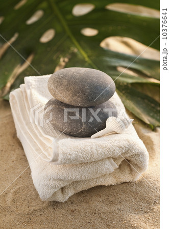 Towel and stones on sand Towel and stones on sand 10376641