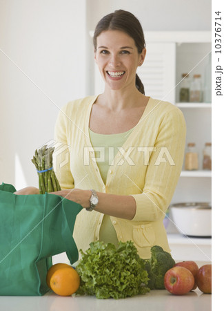 Woman unpacking groceries Woman unpacking groceries 10376714