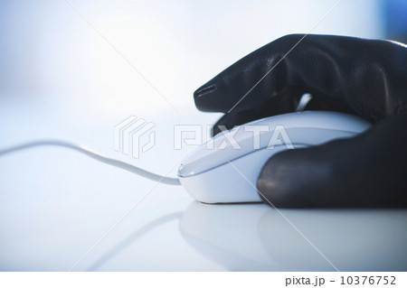 A gloved hand on a computer mouse 10376752