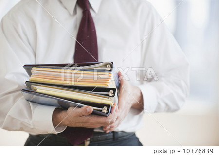 Businessman carrying binders 10376839