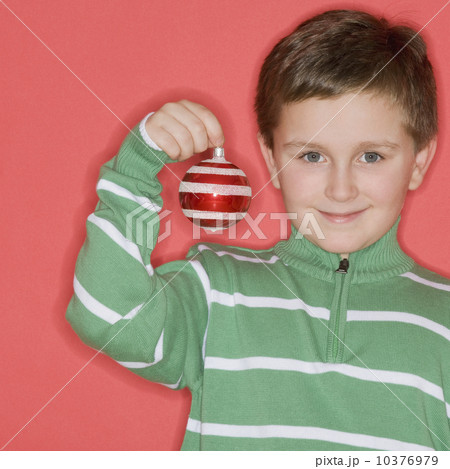 Boy holding Christmas ornament 10376979