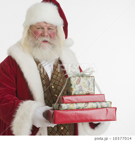 Santa Claus holding stack of gifts 10377014