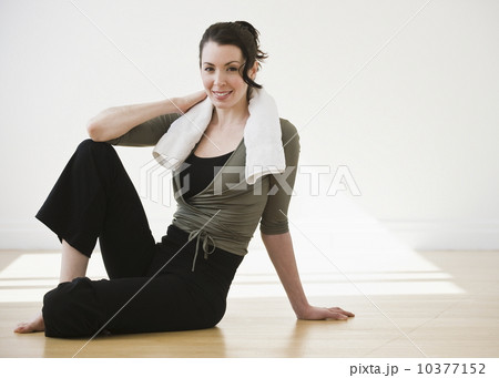 Portrait of woman relaxing after exercise, studio shot 10377152