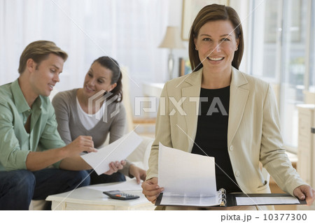 Female financial advisor with couple in background 10377300