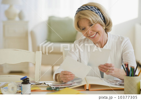 Senior woman looking at photographs 10377305