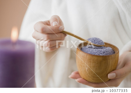 Woman spooning bath salts 10377335