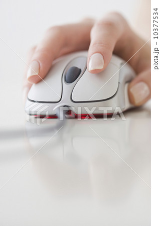 Woman’s hand on computer mouse Woman’s hand on computer mouse 10377534