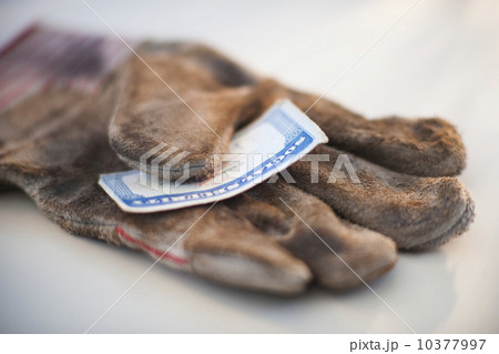 A glove with a social security card on it 10377997