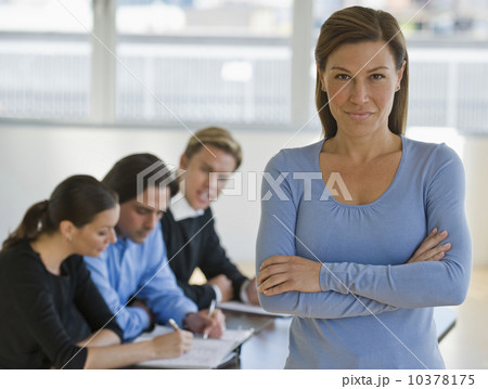 Portrait of businesswoman with business people in background Portrait of businesswoman with business people in background 10378175