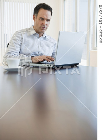 Mature businessman using laptop Mature businessman using laptop 10378570