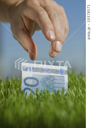 Close up of hand reaching for twenty euro bill 10378571
