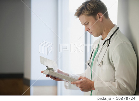 Doctor reading medical chart 10378724