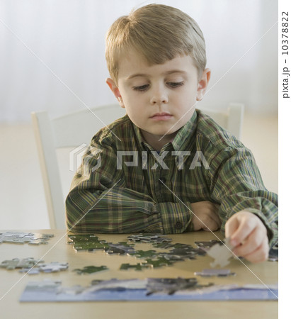 Boy assembling puzzle Boy assembling puzzle 10378822