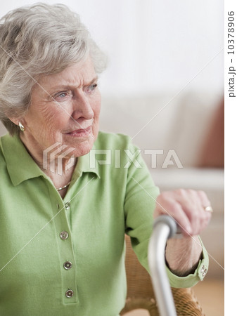 Senior woman sitting and holding walking stick Senior woman sitting and holding walking stick 10378906