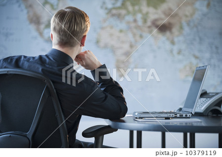 Businessman looking at world map Businessman looking at world map 10379119