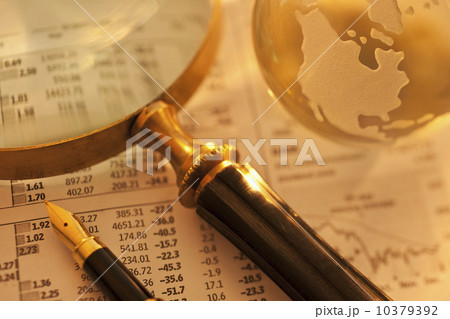 A magnifying glass globe and pen on paperwork A magnifying glass globe and pen on paperwork 10379392