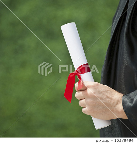 A graduate holding a diploma 10379494