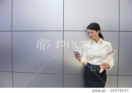 A businesswoman using a personal digital assistant A businesswoman using a personal digital assistant 10379527