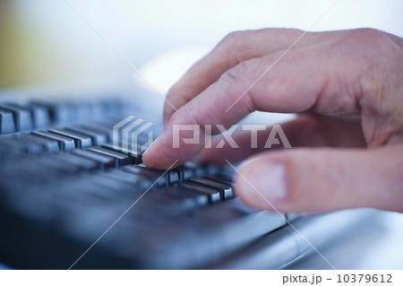 Hand typing on a computer keyboard 10379612