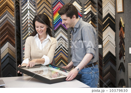 A woman helping a customer at a frame store 10379630