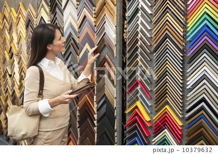 A woman browsing at a frame store A woman browsing at a frame store 10379632