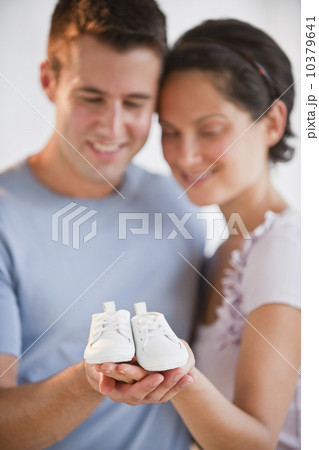 Couple holding baby shoes Couple holding baby shoes 10379641